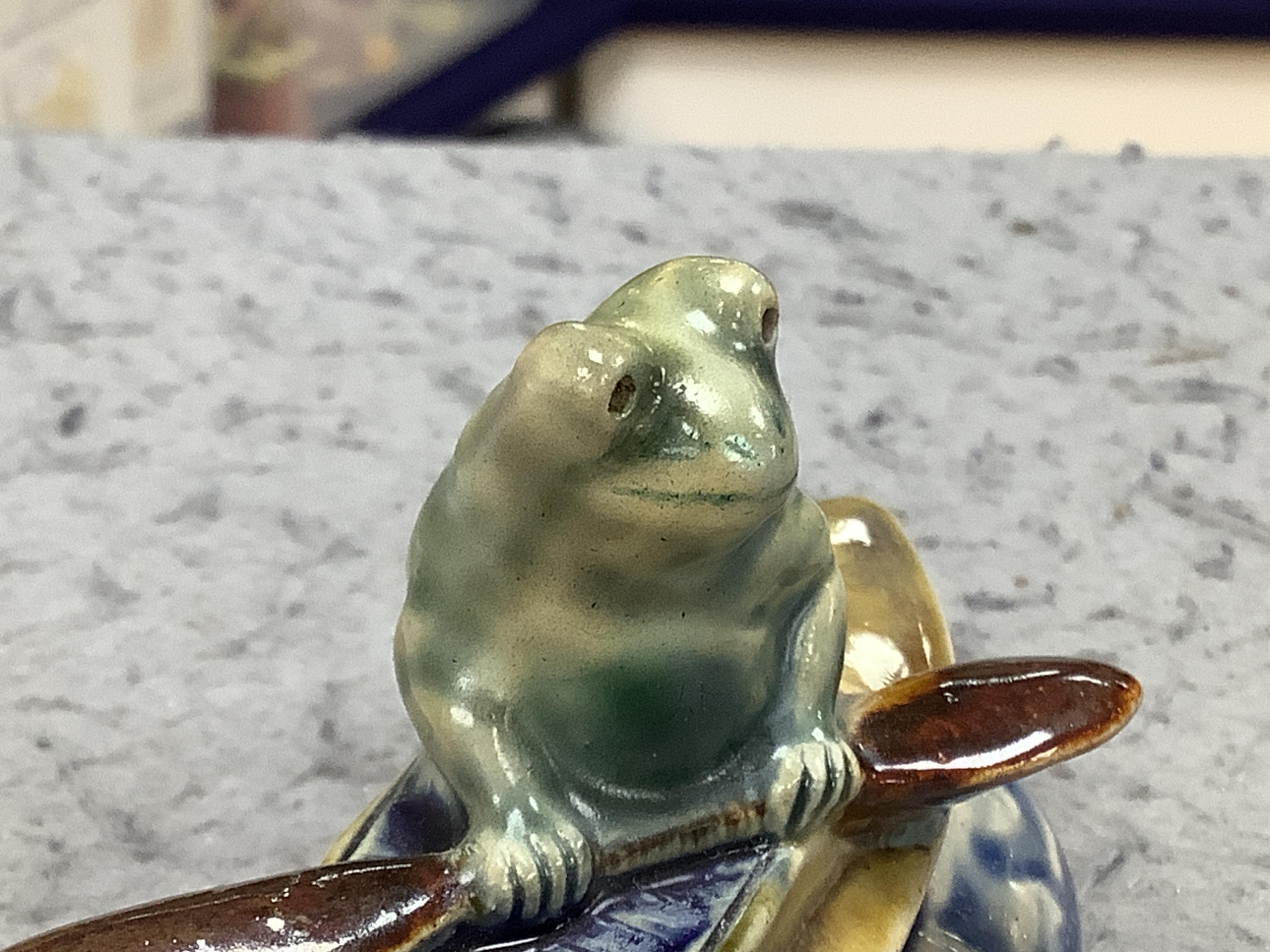 A Doulton Lambeth Kookaburra bibelot with silver tray, a novelty frog in a kayak, a fish jar and figure of a maid, Kookaburra 11cm high. Condition - good